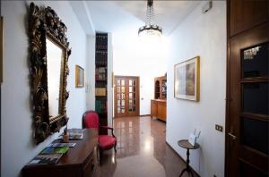 a room with a mirror and a table and a chair at SOFI HOME BERGAMO in Bergamo