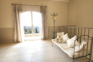 a living room with a bed and a large window at Olives et Libellules in Vence +13 photos