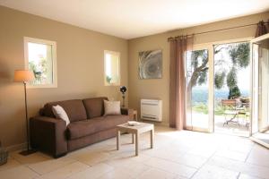 a living room with a couch and a table at Olives et Libellules in Vence