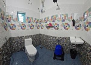 a bathroom with a toilet and a sink at Blue Cove Villa Varkala in Varkala