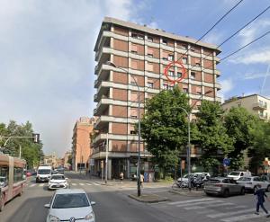 a building on a street with cars parked in front of it at Oriani39 B&B in Bologna
