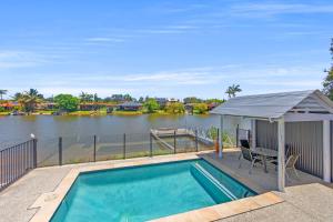 a swimming pool with a gazebo next to a river at Waterfront Paradise in Tweed Heads