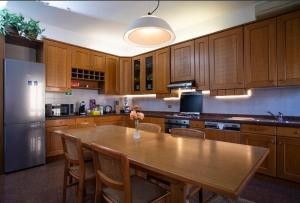 a kitchen with a table with chairs and a refrigerator at SOFI HOME BERGAMO in Bergamo