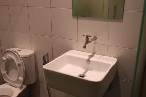 a bathroom with a sink and a toilet at Oscar Inn in Petaling Jaya +18 photos
