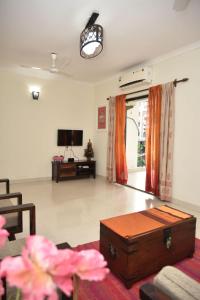 a living room with a couch and a tv at Casa Melora, 2bhk Ac apt in Candolim, Beachwalk in Candolim