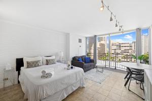 a bedroom with a bed and a living room at Waikiki Ilikai Marina in Honolulu