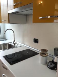 a kitchen with a sink and a counter top at Casa Mama in Rho