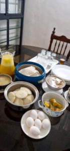 a table with a bunch of food on a table at Blue Cove Villa Varkala in Varkala +16 photos