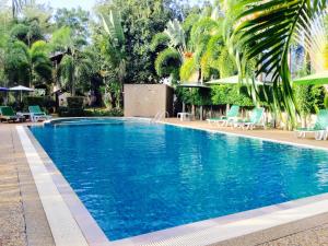 a swimming pool with blue water in a resort at Wild Orchid Villa Krabi in Ao Nam Mao