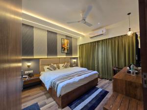 a hotel room with a bed and a desk and a bed sidx sidx at Hotel Fortune in Ayodhya