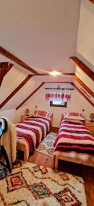 a room with two beds in a attic at Vlad De Săliște in Săliştea de Sus