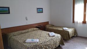 Postel nebo postele na pokoji v ubytování Albergo Sonia