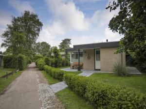 a house with a garden and a road at Sint Maartenszee Renovated Family Retreat in Sint Maartenszee
