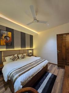a bedroom with a bed and a ceiling fan at Hotel Fortune in Ayodhya