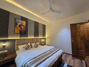 a bedroom with a bed and a ceiling fan at Hotel Fortune in Ayodhya