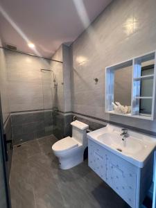 a bathroom with a toilet and a sink at Khách sạn Thanh Tâm in Nha Trang
