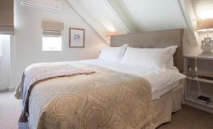 a bedroom with a large bed with white pillows at Klein Welmoed Luxury Guest House in Stellenbosch