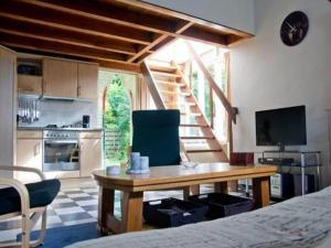 a living room with a wooden table and a kitchen at Holiday home in Petten near beach in Petten