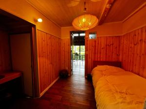 una camera da letto con un letto in una stanza con pareti in legno di 六弥苑 a Matsuzaki