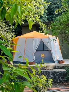 an orange and white tent sitting on some steps at Gaia Ekole in Āmbavna