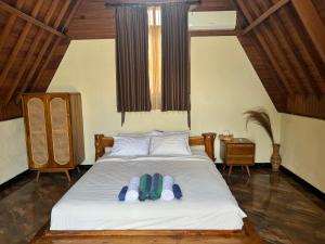 Postel nebo postele na pokoji v ubytování Ringsun Homestay Uluwatu
