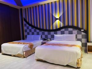 Katil atau katil-katil dalam bilik di Wei Feng Exquisite Motel Pintung Branch