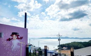 a wall with a painting of a girl on it at Namhae Moonlight 2gram Pool Villa Pension in Namhae