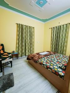 a bedroom with a bed and a chair at Shri Ganesh Homestay in Prayagraj +25 photos