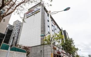 a building with a sign on the side of it at Daecheon Island Hotel in Boryeong