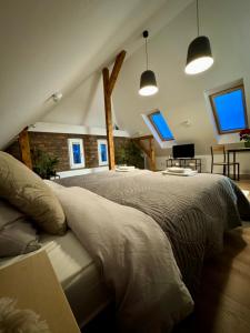 a bedroom with a large bed in a attic at Apartamenty Astor - Księżycowy in Szczawno-Zdrój