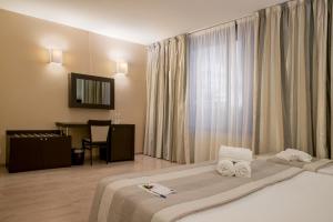 Postel nebo postele na pokoji v ubytování Hotel Executive