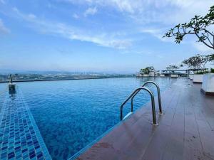 a swimming pool with a view of the water at SRH EVO Duplex Suites in Bandar Baru Bangi