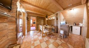 a kitchen in a log cabin with a wooden ceiling at Domek Marców in Ustrzyki Dolne