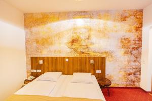 Postel nebo postele na pokoji v ubytování Hotel Klimt
