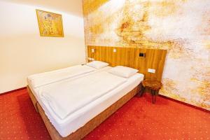 Postel nebo postele na pokoji v ubytování Hotel Klimt