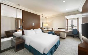 a hotel room with a bed and a desk at Radisson Blu Hotel and Convention Center, Riyadh Minhal in Riyadh