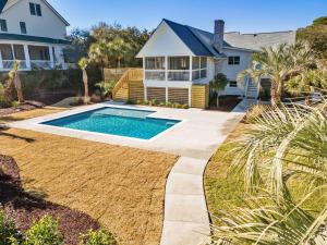 a house with a swimming pool in a yard at High Seas in DeBordieu Colony home by Peace Vacations in Georgetown