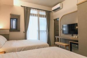 Posteľ alebo postele v izbe v ubytovaní Yuzhi Wenlv B&B