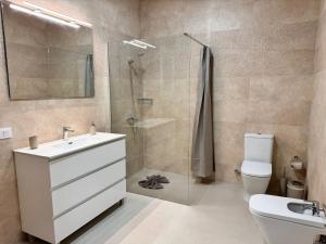 a bathroom with a shower and a sink and a toilet at Apartamento Cerca de Maspalomas in Salobre +11 photos