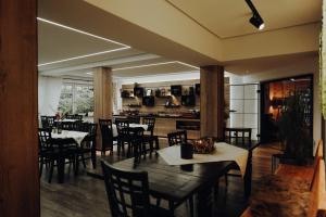 a restaurant with tables and chairs and a kitchen at Das kleine Hotel Lahnau in Lahnau