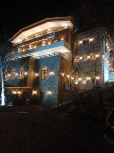 a large building with lights on it at night at Bujtina Çupa in Klos