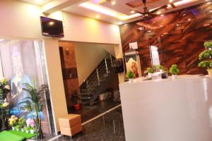 a lobby with potted plants on the wall at Golden IB'S Gokarna in Gokarna
