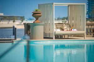 a view of a swimming pool with a planter next to a couch at Palazzo Versace Dubai in Dubai