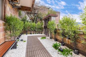 a garden with plants and a building at Pet Friendly Nostalgic Inn in Jiufen