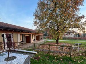 a yard with a tree and a fence at i mirtilli in Pianezze
