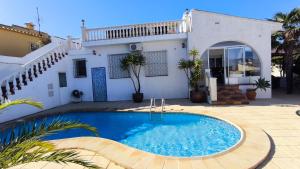 a swimming pool in front of a house at Casa Marie - Albir in Albir