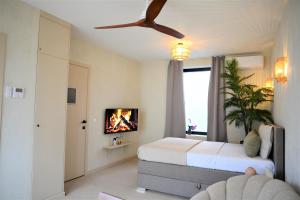 a bedroom with a bed and a ceiling fan at SLEEP INN - Kyoto Suites South Antwerp in Antwerp