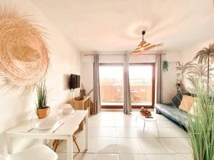 a living room with a couch and a table at Studio calme -304- in Canet-en-Roussillon