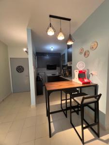 a kitchen with a table and chairs in a room at SweetHome in Ipoh