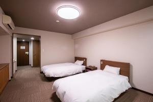 Postel nebo postele na pokoji v ubytování Hotel Umenoyu